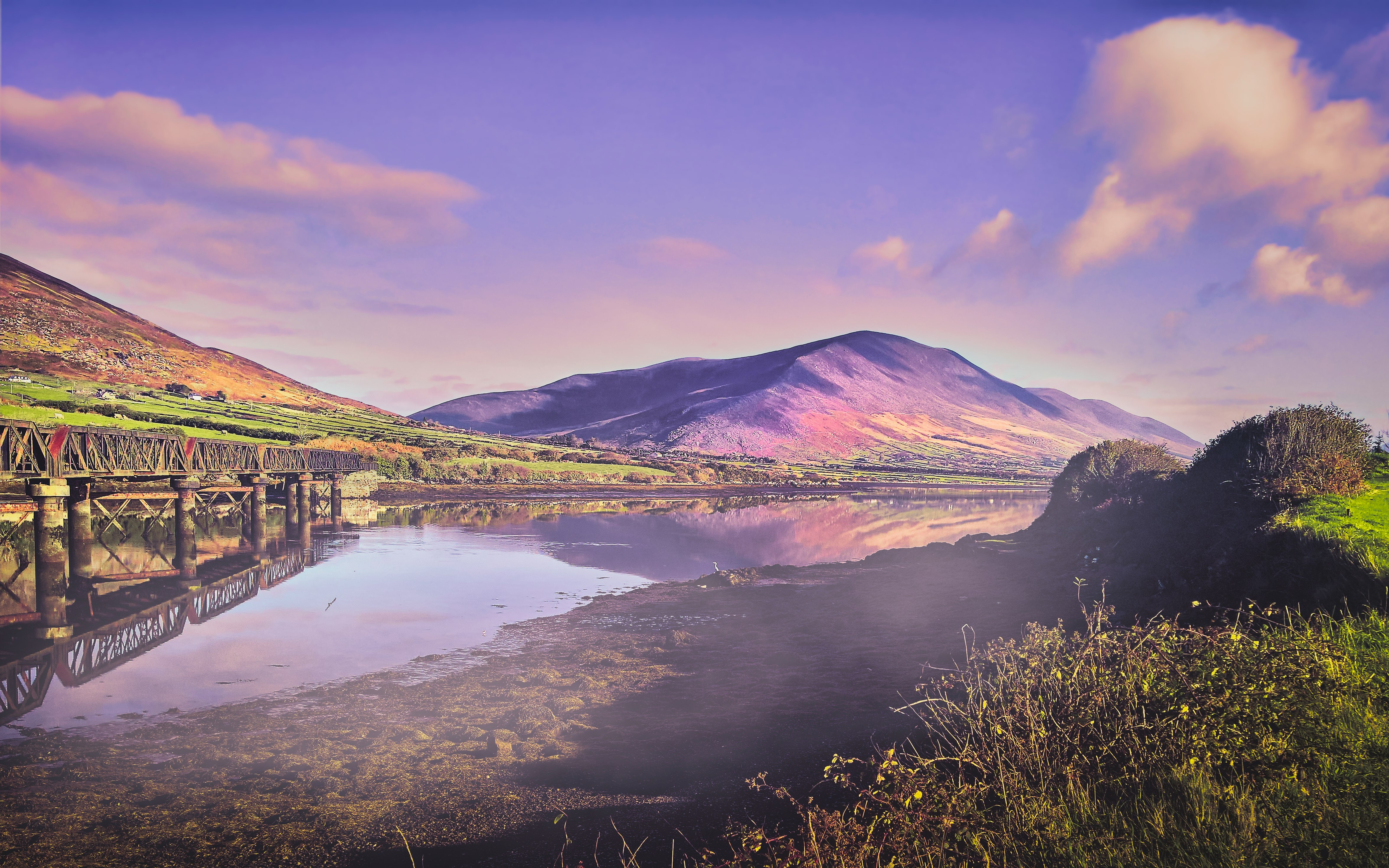 body of water near mountain during daytime